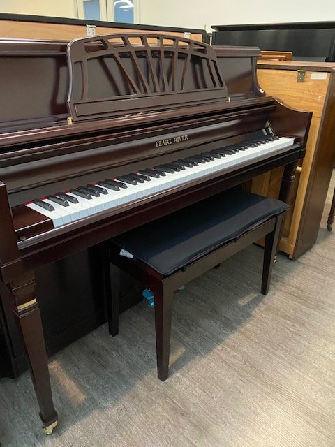 “Like new” Pearl River console piano